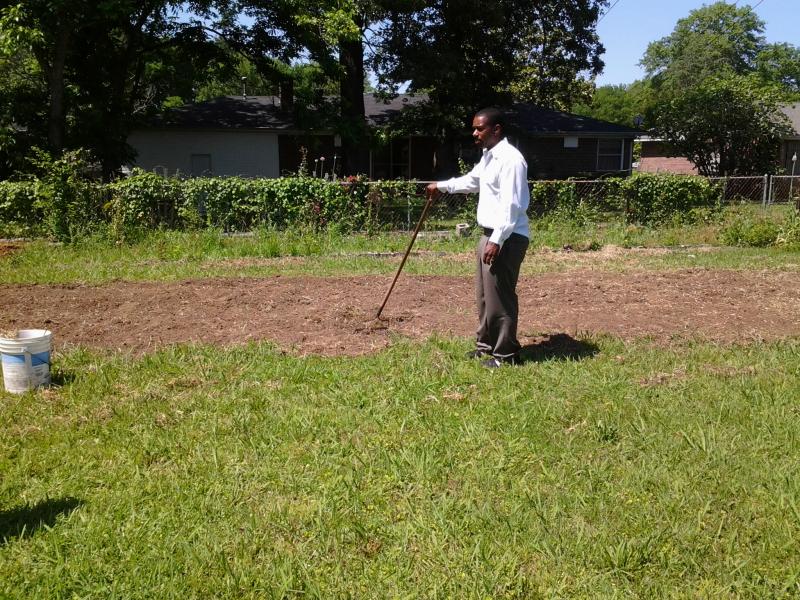 Pastor Charles leads us in prayer at the site of our garden.
